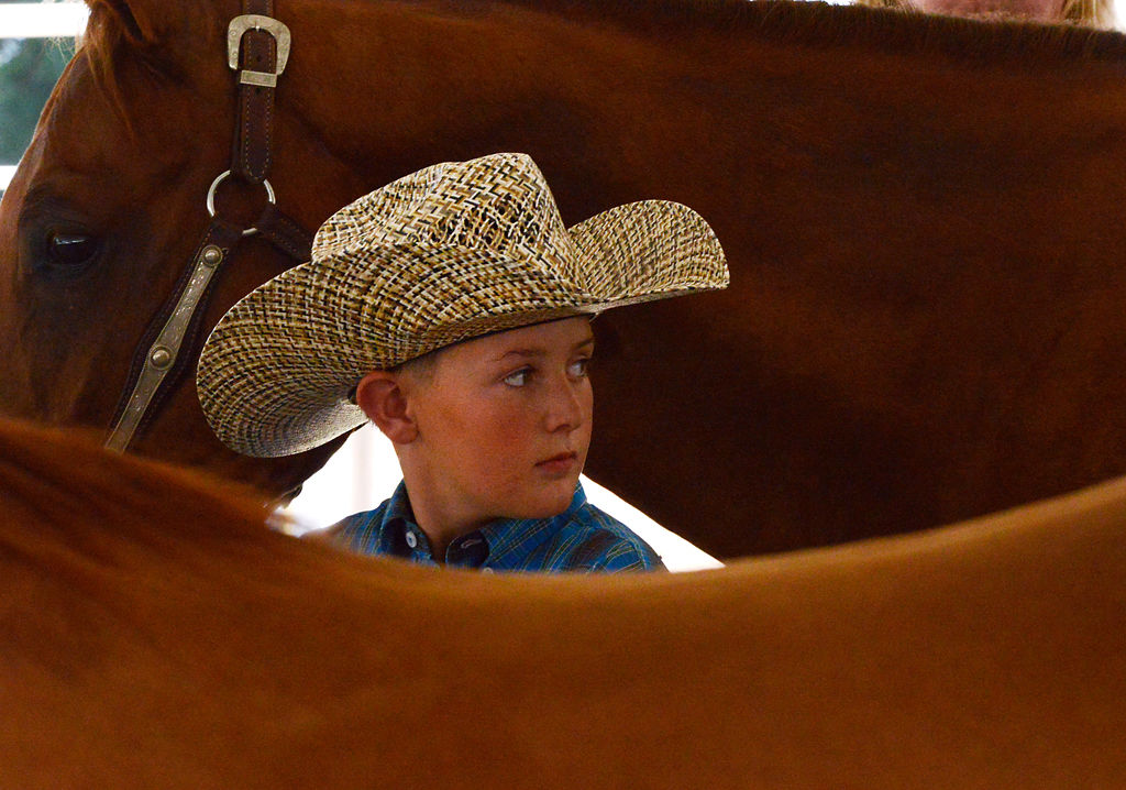 Hunter Skouby, 10, leads his horse Bugs through the waiting tent before he competes